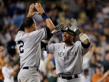 Robinson Cano is congratulated by Derek Jeter after hitting a two- run homerun in the 10th inning off Dodgers reliever George Sherrill.