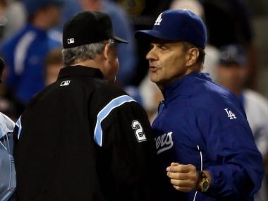 Los Angeles Dodgers manager Joe Torre is restrained by third base umpire Jerry Crawford during an argument with the home plate umpire over balls and strikes on Sunday.