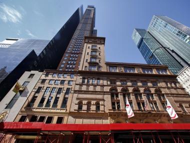 Construction moves forward on the Carnegie Hall studio towers after the last remaining tenants agree to leave the building.