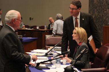  Ald. Edward Burke talks with Chief Financial Officer Lois Scott during a break in Monday's committee meeting. 
