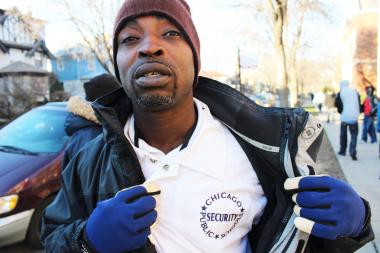  Anthony Andrews said he works for Chicago Public School as a security officer. He stood outside Sullivan High School, 6631 N. Bosworth, Wednesday as added security. 
