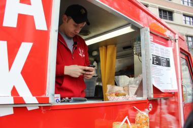  Salsa Truck owner and operator Dan Salls processes credit card purchases on his smart phone. 