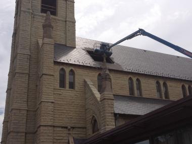  Construction crews hammer away sections of the roof at the historic church in Bronzeville. 
