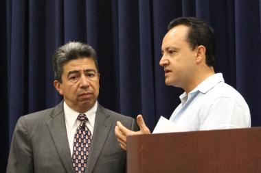  Aldermen Danny Solis and George Cardenas discuss last weekend's immigration raid before their Wednesday news conference. 
