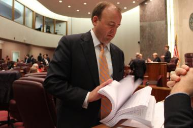  Ald. Brendan Reilly flips through letters from building owners who he said oppose energy benchmarking. 
