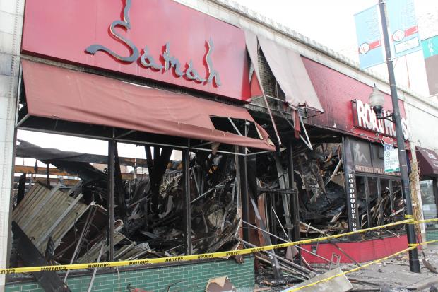  Crews began demolition Saturday on the building housing three businesses ruined in Friday night's fire. 
