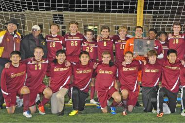  St. Ignatius College Prep boys soccer head coach Jim Luzzi (top row, second from l.), with his team after its super-sectional victory over Antioch. The win advanced the Wolfpack to the IHSA state semifinals, which take place Friday, for the first time. 
