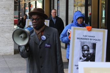  Wallace "Gator" Bradley leads protesters outside the offices of Cook County State's Attorney Anita Alvarez. 
