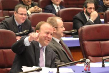  Ald. Brendan Reilly points to the City Council media area after putting away an e-cigarette he was encouraged to sample. 
