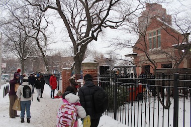  Parents and students gather outside Ray Elementary in the snow. 
