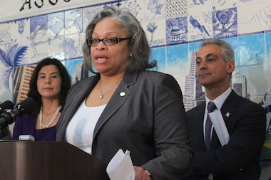  Flanked by State's Attorney Anita Alvarez and Mayor Rahm Emanuel, Ald. Deborah Graham, herself a victim of domestic violence, cheers the new task force. 
