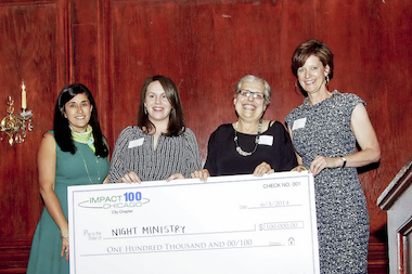  Members of the Night Ministry organization pose with the $100,000 grant check from Impact 100. 