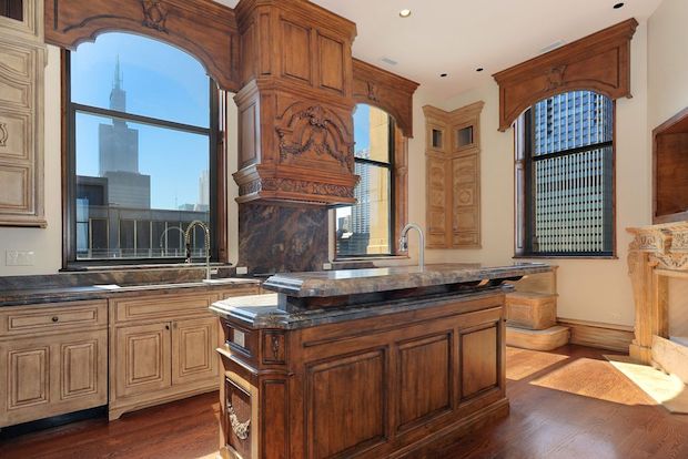  The $3.89 million condo includes 13-foot ceilings, five marble gas fireplaces and a marble staircase. 