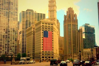  An American flag is draped on the Wrigley Building in preparation for July 4. 