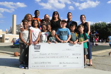  Students and parents from Pritzker School received a check for $8,575 from the West Town Chamber of Commerce on Wednesday.  The proceeds were from Do-Division Fest gate donations. 