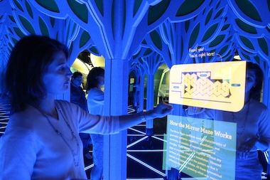  Senior Exhibit Designer Olivia Castellini shows the motion sensors that bring up a map and other features in the maze. 