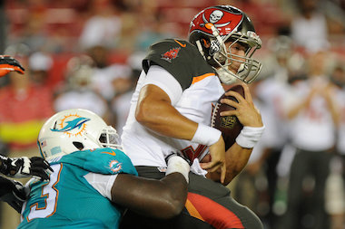  Quarterback Mike Kafka of the Tampa Bay Buccaneers is sacked by defensive tackle Kamal Johnson of the Miami Dolphins in the second half at Raymond James Stadium on Aug. 16, 2014 in Tampa, Fla. 