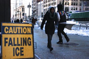  Pedestrians passing a word of caution on Michigan Avenue.  