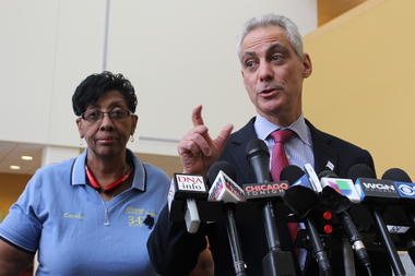  Mayor Rahm Emanuel, backed by Ald. Carrie Austin (l.), suggests Garcia isn't being honest with voters over the costs of his programs. 