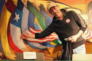  Candidate Jorge Mujica poses with an empty chair, marked with a nametag for veteran Ald. Danny Solis, at a debate last week. Solis said he would not be able to attend the forum because of a scheduling conflict. 