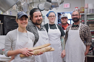  Sauce and Bread Kitchen owners Mike Bancroft and Anne Kostroski (foreground) were featured in the Obama Foundation's announcement it would move to Chicago. 