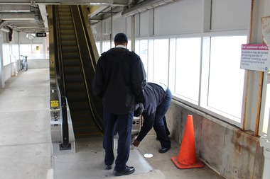  CTA workers try to get the elevator started at the Green Line stop at 35th Street — no luck. 