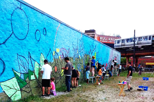  About 100 people came out over the weekend to help paint the mural. 