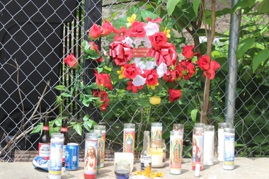  Family lit candles and laid a wreath creating a makeshift memorial for 17-year-old Jeremy Salinas in Bridgeport in June. 