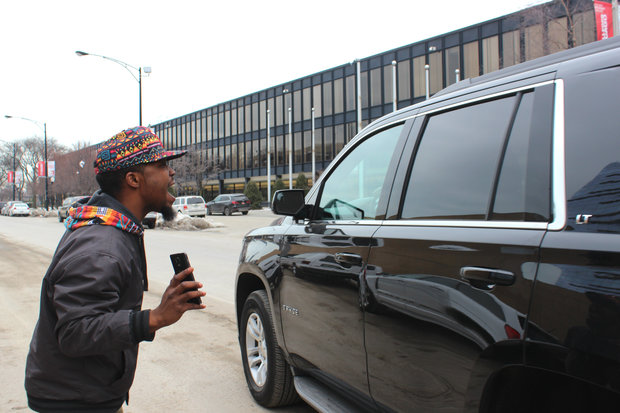  Washington Park resident Jared Steverson yells at an SUV carrying Mayor Rahm Emanuel Thursday. After staking out the location, Steverson had a brief encounter with Emanuel outside of Malcolm X College. 