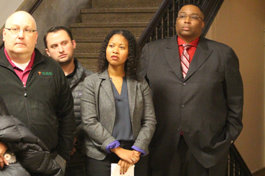  Tanya Triche, of the Illinois Retail Merchants Association, and Ald. Jason Ervin listen to small-business owners complain about the tobacco tax. 