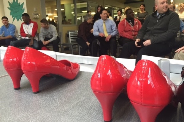  A group of male participants listens to statistics on violence against women just ahead of the Walk a Mile in Her Shoes event last year. The march aims to put a spotlight on rape, sexual assault and gender violence. 