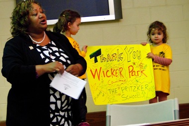  Pritzker School Principal Joenile Albert-Reese and students say thanks for a $5,000 donation. 