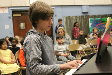  Anthony Repetyuk, a student at Franklin, playing the piano at the school's annual recital. 