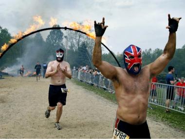 Aristide Economopoulos of The Star-Ledger took first place for sports picture for his series of photos of the Tough Mudder race in PA. Michael Dacko, right, and Robert Ward, both members of the team Much Macho who all dressed as Mexican wrestlers, celebrate Crossing the Ring of Fire to finish the Tough Mudder challenge. 