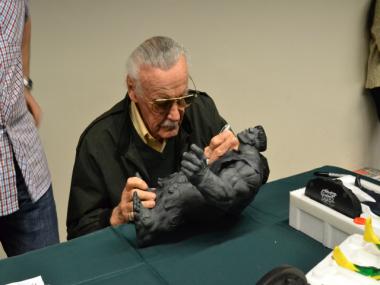 Famed comic book illustrator Stan Lee autographs a model of the Incredible Hulk at the Annual One Day Comic Book Show on Saturday, Mar. 31, 2012. 