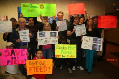 Users of the park underneath the Queensboro Bridge with signs of protest against the tennis bubble on April, 26. 