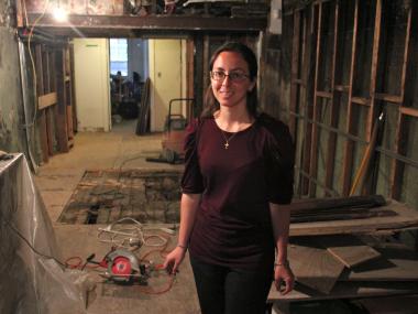 Kathleen O'Hara inside the basement of 97 Orchard St., where artifacts were uncovered from two fireplaces.  