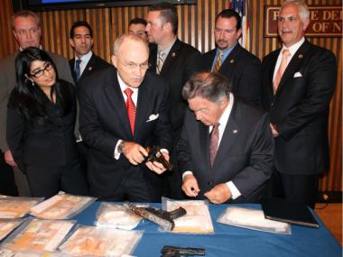  Police Commissioner Raymond Kelly and Queens District Attorney Richard Brown examine weapons seized during a separate investigation. 
