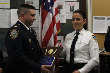  Captain David Miller presents a plaque to former 10th Precinct commander Inspector Elisa Cokkinos on May 22, 2013. 
