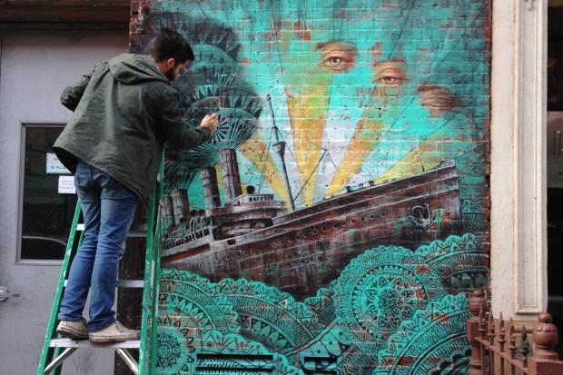  Beau  Stanton installed the Little Italy mural "Cursum Perficio."  
