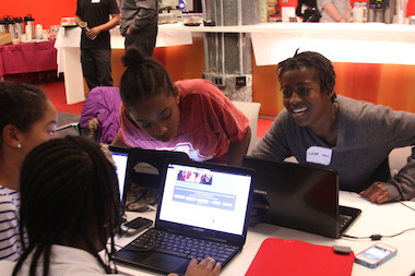  Lake Sheffield, right, jokes with others at a Black Girls Code event in December 2013. The organization is one of several in the city focused on improving girls' science and math skills. 