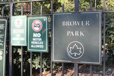  A sign outside of Brower Park. A man walking his dog found a dead woman in the park Saturday afternoon, police said. 