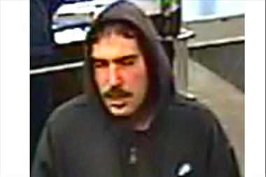  Police are looking for a man in his 40s, weighing about 180 Ibs, who robbed two banks. 