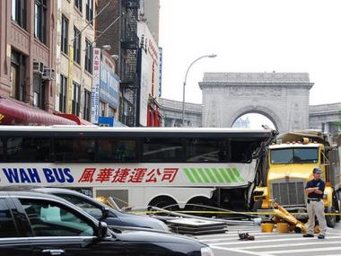 The scene at Canal and Bowery on June 23, 2008 when a commercial dump truck rammed into a bus in Chinatown, sending it onto the sidewalk and crashing into the front of a bank. Four people were injured and a 57-year-old woman died.