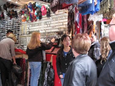 Chinatown hawkers line a crowded Canal Street selling goods to shoppers and tourists. A new law proposed by Councilwoman Margaret Chin would punish buyers of knockoff designer bags.