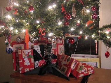 Wrapped gifts wait under the Christmas tree.