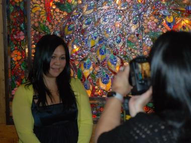 Joanna Blanco takes a photo of her sister, Lani Blanco, in front of a glass decoration at Tavern on the Green.