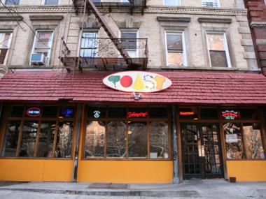 Lionel McIntyre, an urban planning professor at Columbia, is accused of punching a female coworker at Toast on Broadway near 125th Street in Morningside Heights on Nov. 6, according to a criminal complaint.