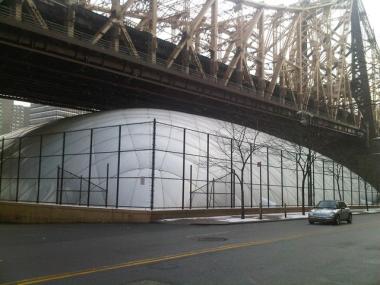 The Sutton East Tennis Club's bubble under the Queensboro Bridge. The Parks Department withdrew its agreement to allow the bubble to stay up year-round Thursday.