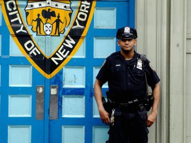 A police officer stands outside the 1st Precinct in Manhattan. There have been 16 murders in Manhattan over the first 11 weeks of the year, according to NYPD crime statistics.